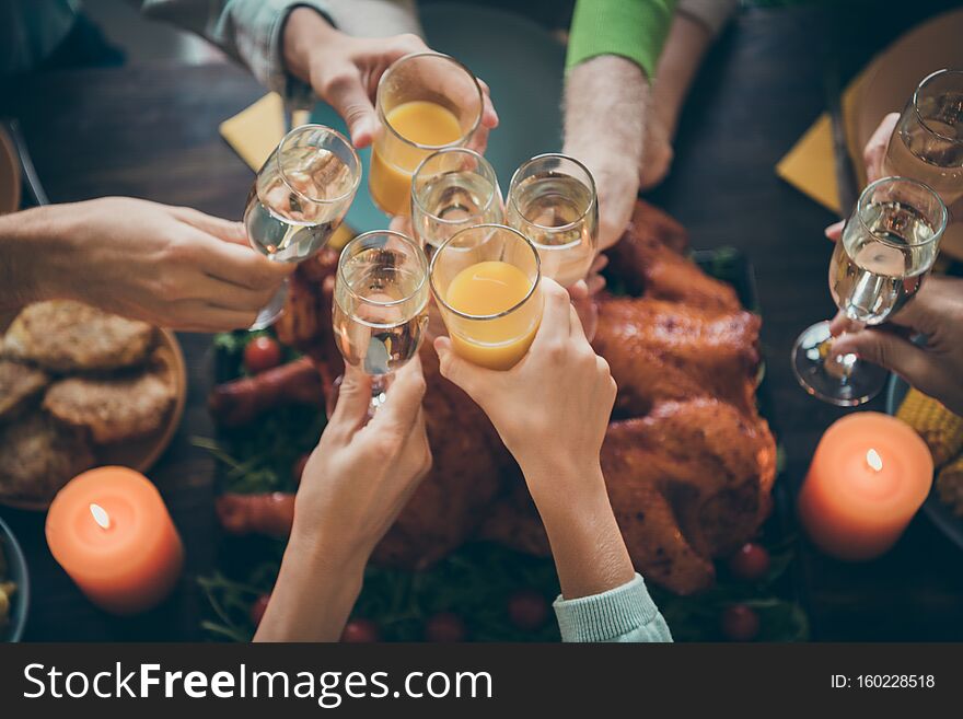 Cropped close-up view of nice big full family brother sister couples clinking glass orange juice beverage gratefulness