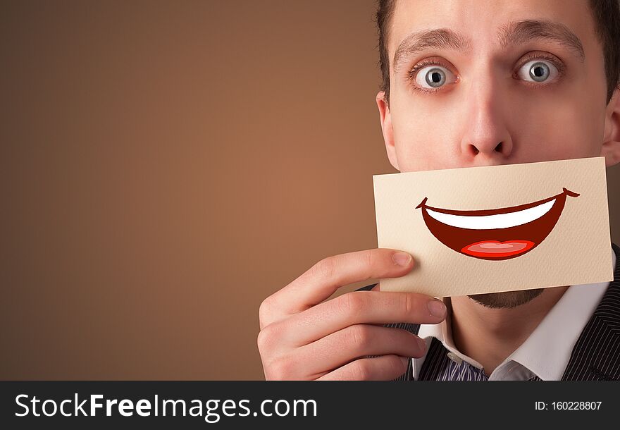 Person holding card in front of his mouth