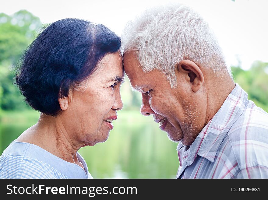 Asian couples who have lived together for over 50 years, put their foreheads close together, smiling and happy. Take care of each other for life. Senior community concept. Asian couples who have lived together for over 50 years, put their foreheads close together, smiling and happy. Take care of each other for life. Senior community concept