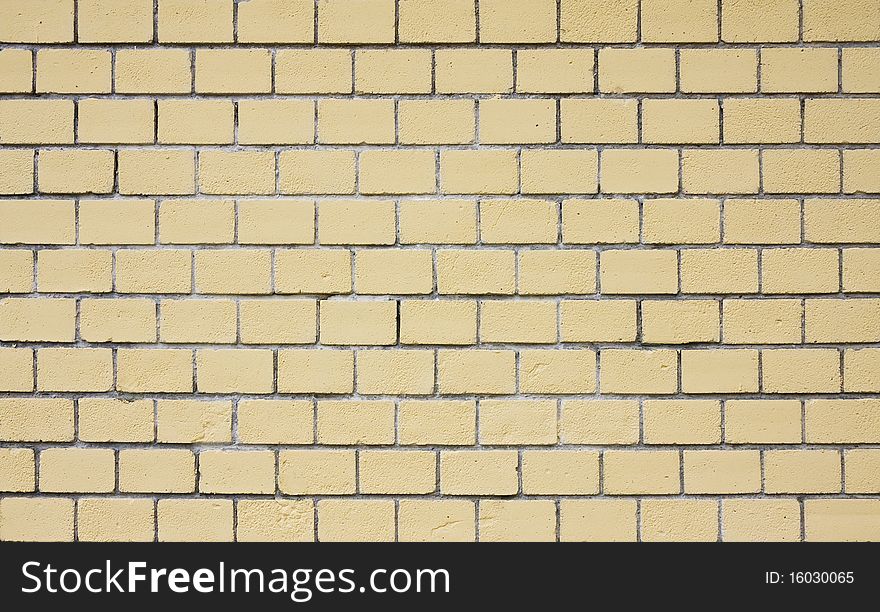 Yellow weathered brick wall background. Close up. Yellow weathered brick wall background. Close up