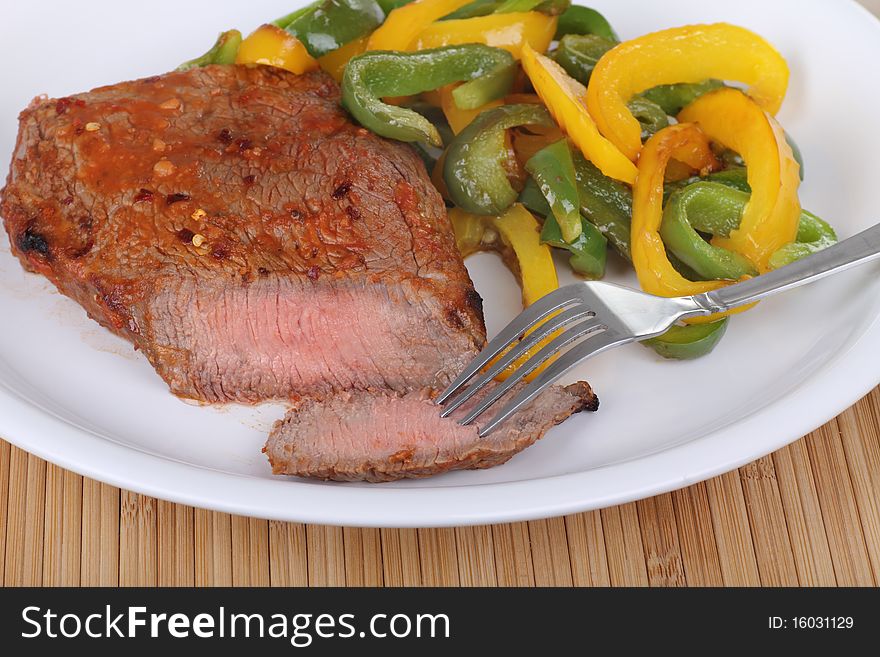Pepper sirloin steak with green and yellow bell peppers. Pepper sirloin steak with green and yellow bell peppers