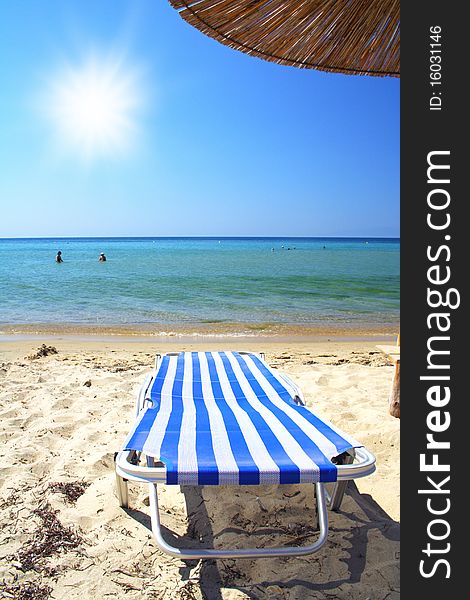 Beach with sunbed and umbrella in summer