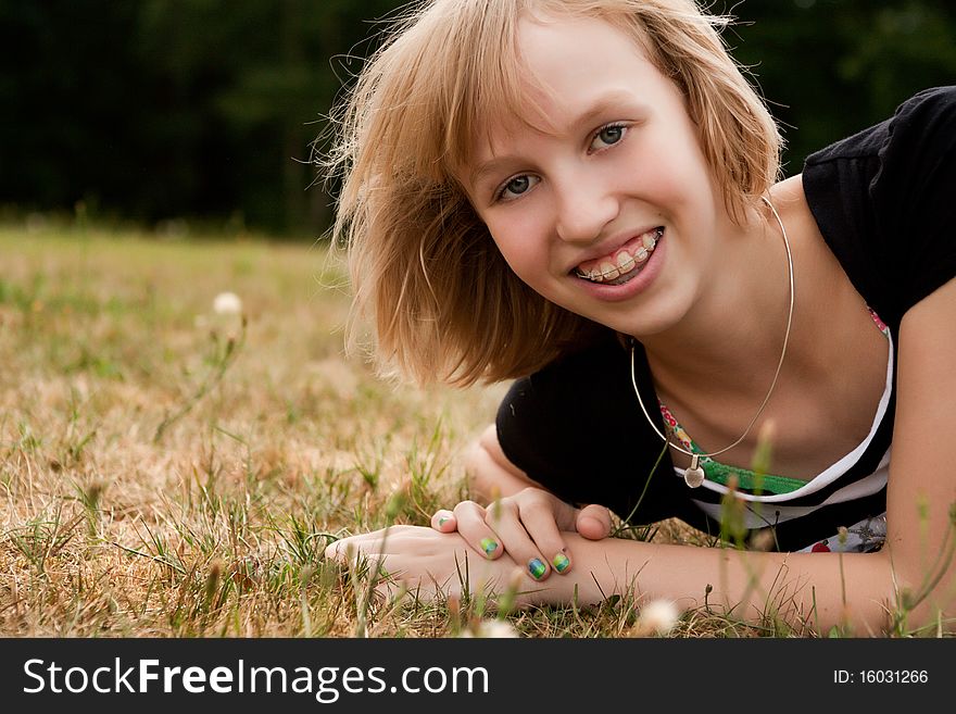 Young summer girl portrait in the grass. Young summer girl portrait in the grass