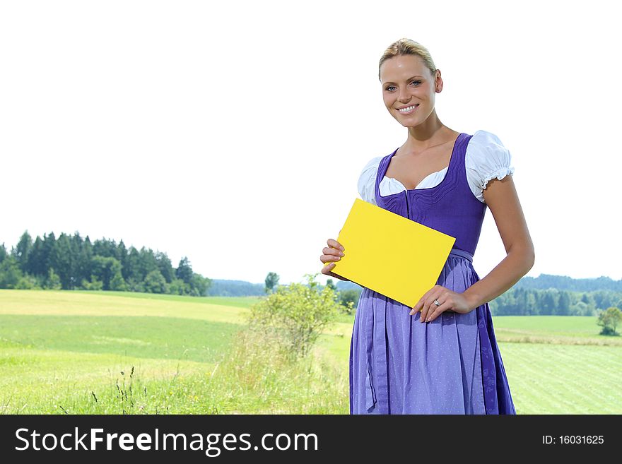 Beautiful bavarian Girl holding a yellow plate