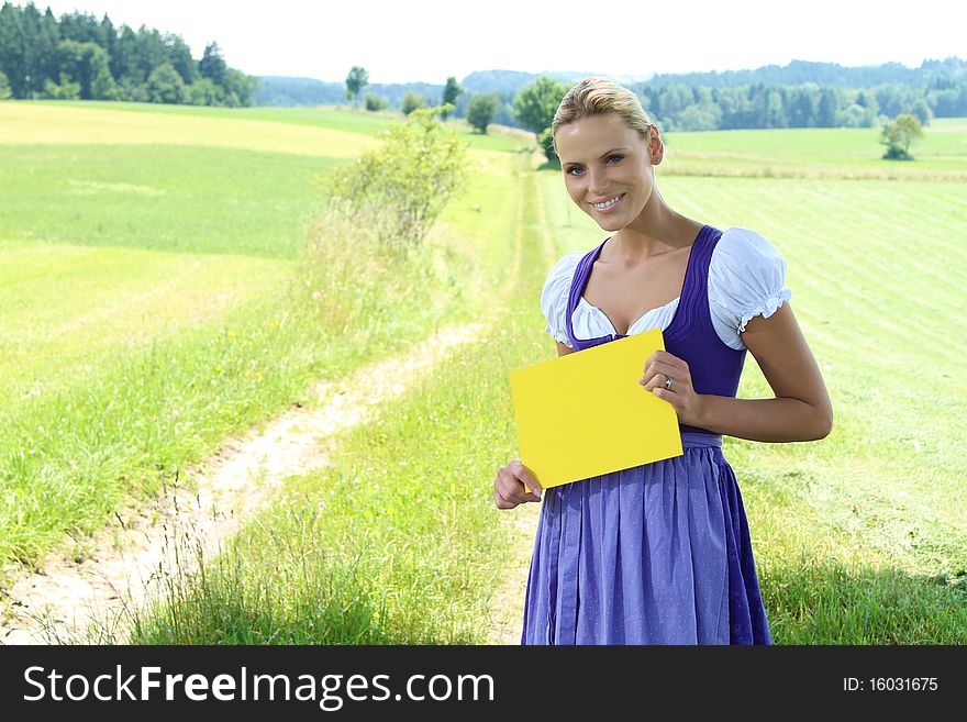 Beautiful bavarian Girl holding a yellow plate