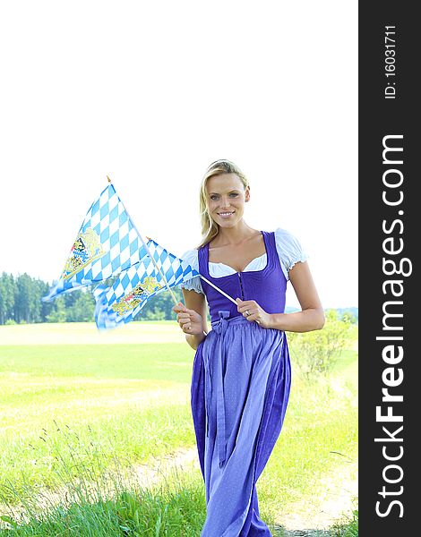 Beautiful bavarian Woman with flags