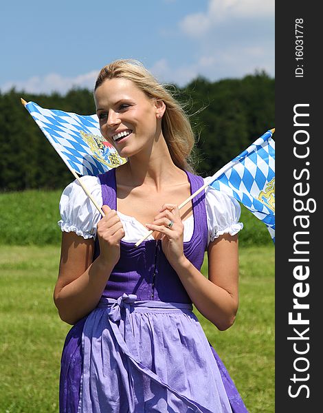 Beautiful bavarian Woman with flags