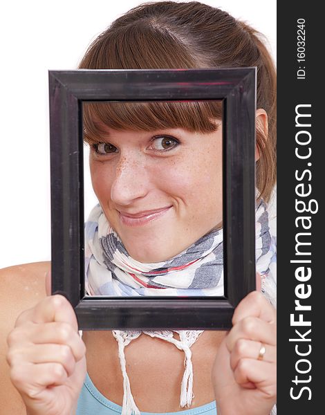 Happy woman looking through photo frame over white background. Happy woman looking through photo frame over white background