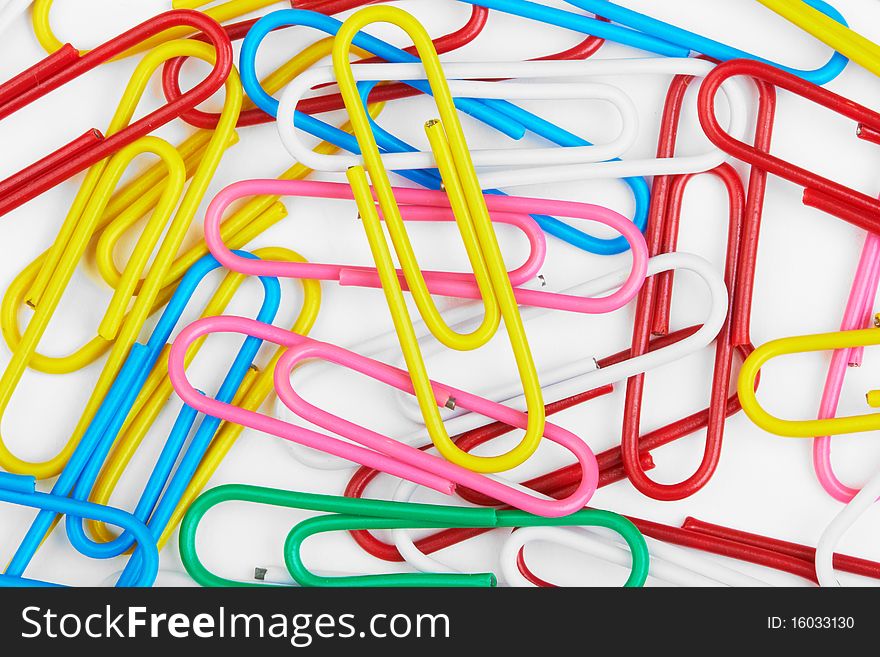 Close-up of multi-coloured paper clips background