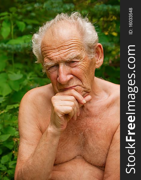 Close-up portrait of a pensive senior man holding his hand near his face. Close-up portrait of a pensive senior man holding his hand near his face