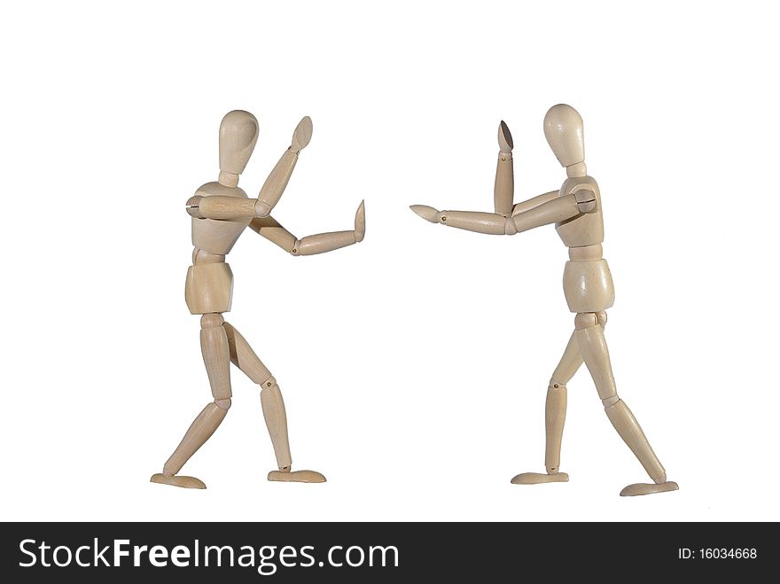 Fighting wooden dummies on white background