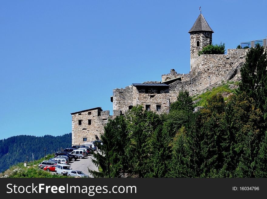 Image shows a part of Castle Landskron with some forest, Carinthia, Austria, in front of blue sky. Image shows a part of Castle Landskron with some forest, Carinthia, Austria, in front of blue sky.