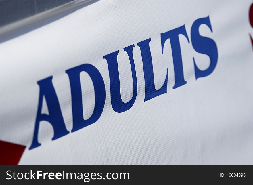 Adults sign on white banner. Adults sign on white banner