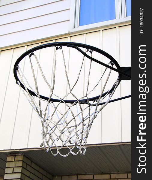 Basket next to white façade. Basket next to white façade