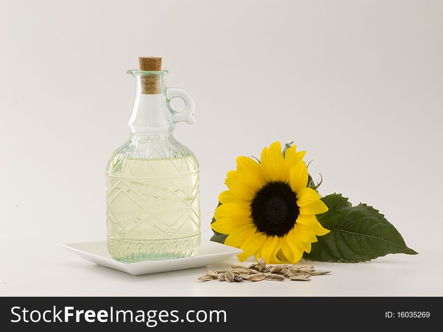 Sunflower oil bottle and seeds. White background. Sunflower oil bottle and seeds. White background.