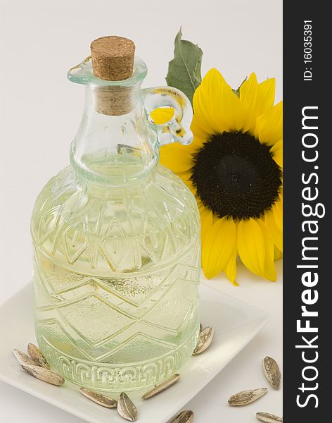 Sunflower oil bottle and seeds. White background. Sunflower oil bottle and seeds. White background.