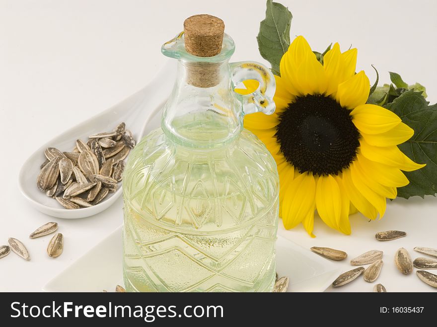 Sunflower oil bottle and seeds. White background. Sunflower oil bottle and seeds. White background.