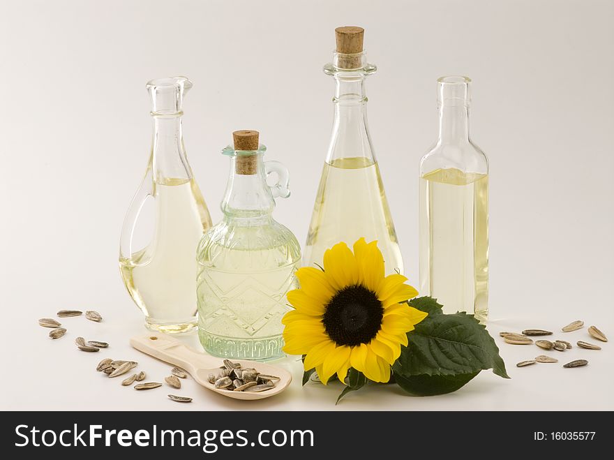 Sunflower oil bottles and seeds. White background. Sunflower oil bottles and seeds. White background.