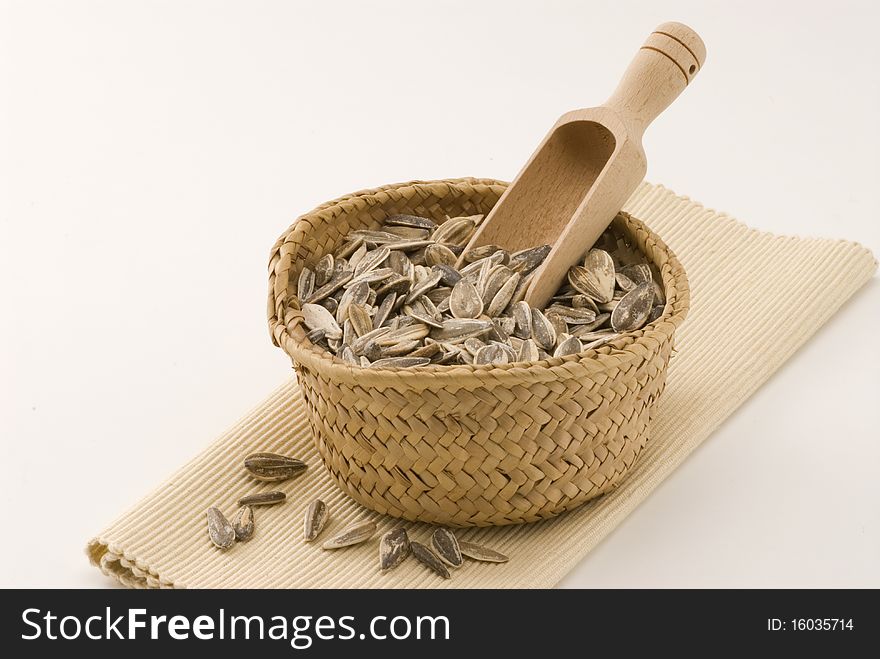 Dried sunflower seeds in a basket. White background. Dried sunflower seeds in a basket. White background.