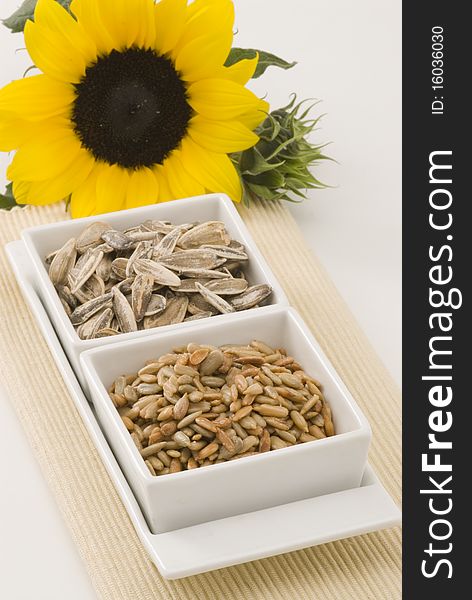 Dried sunflower seeds in square white bowls. Dried sunflower seeds in square white bowls.
