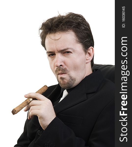 Business man in black suit smokes a cigar. Business man in black suit smokes a cigar