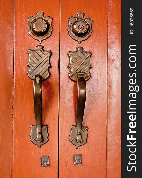 Old copper door knob at ancient style door. Old copper door knob at ancient style door