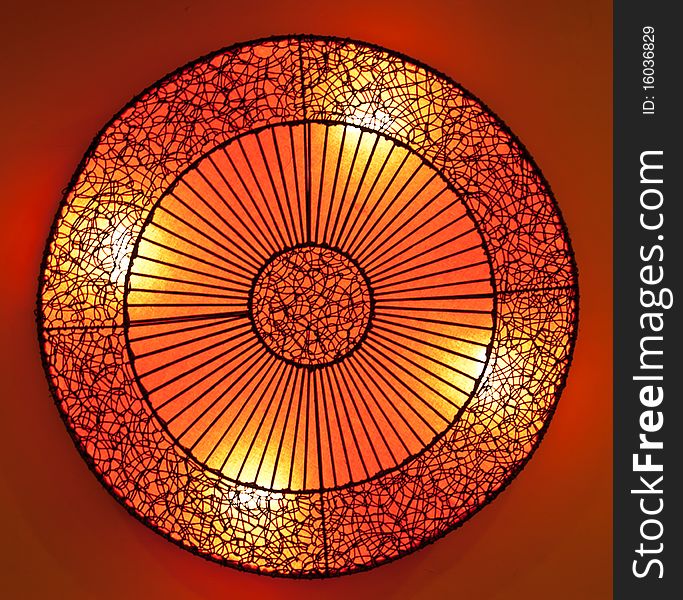 Circle rattan lamp with orange paper in restuarant. Circle rattan lamp with orange paper in restuarant