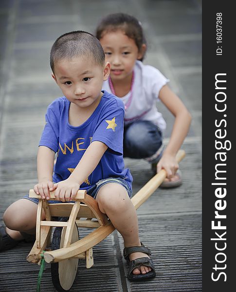 Sister and brother play wood trolley. Sister and brother play wood trolley.