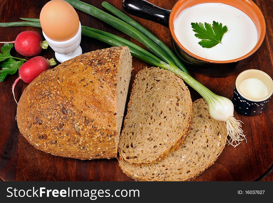 Loaf of bread with vegetables, sour cream and egg on the tablet. Loaf of bread with vegetables, sour cream and egg on the tablet