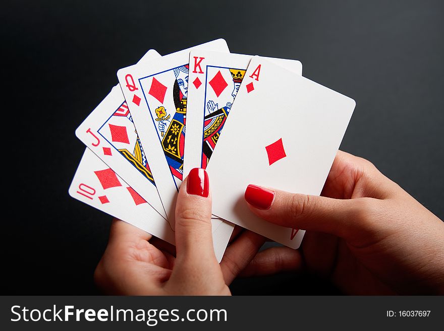 Diamonds Royal Flush in Female Hands isolated on a black background