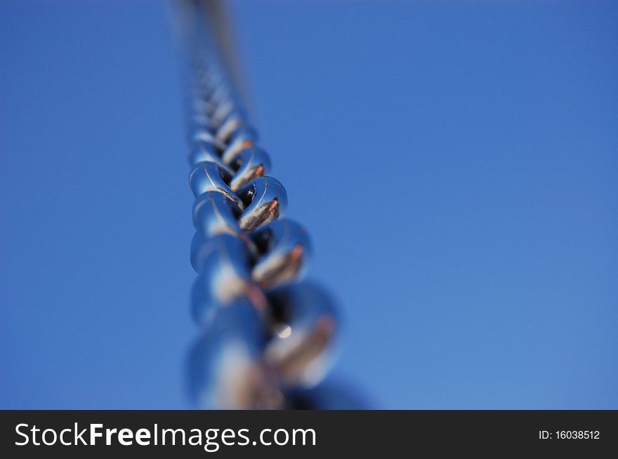 Metal chain against the blue sky. Metal chain against the blue sky