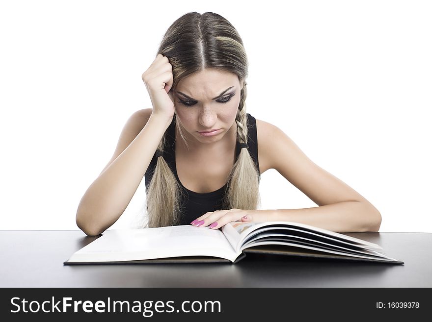 Young pretty girl reading a book