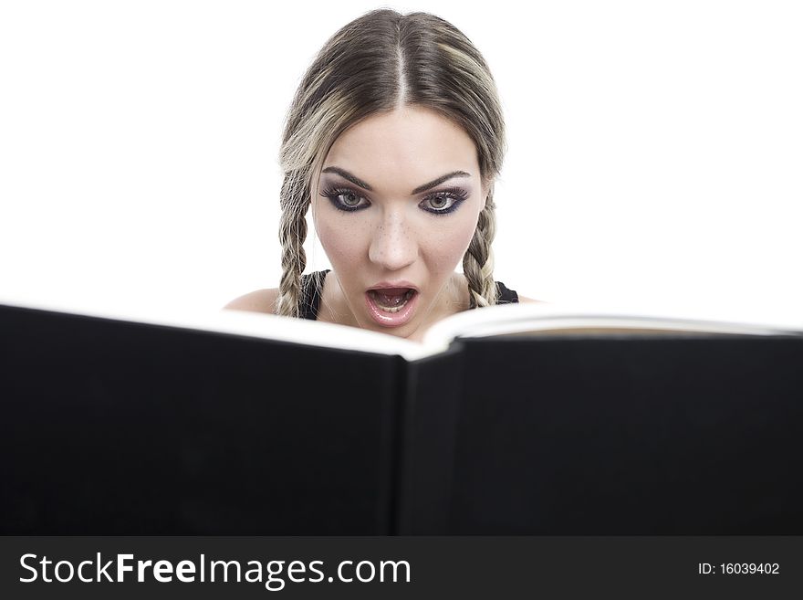 Young pretty girl reading a book