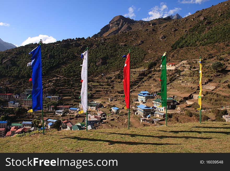 Prayer flags fly in the mountain village of Namche Bazaar, Himalayas, Nepal. Prayer flags fly in the mountain village of Namche Bazaar, Himalayas, Nepal.