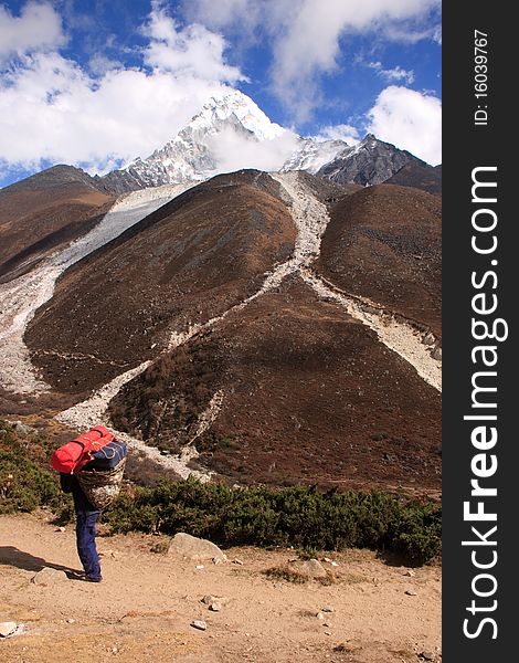 A sherpa earns from his trade, carrying trekking equipment in the Himalayas. A sherpa earns from his trade, carrying trekking equipment in the Himalayas.