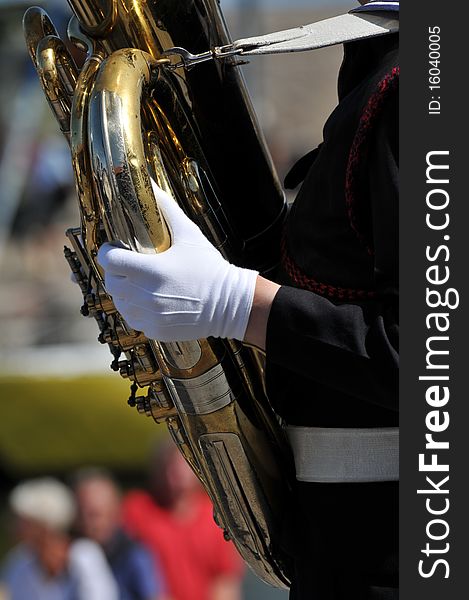 Detail of a musician with brass instrument