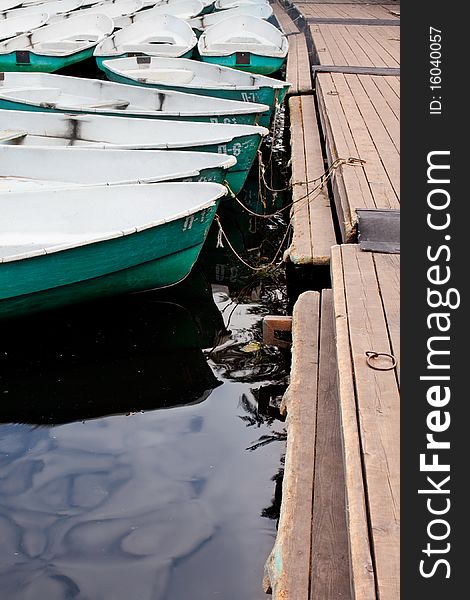 Green boat on the water near the pier