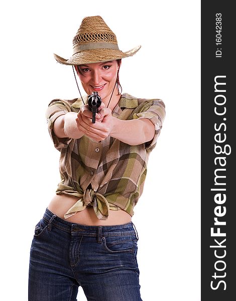 Super rodeo cowgirl in torn jeans, boots and cowboyhat. Portrait of Cowboy Holding Gun Up.