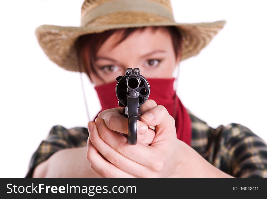 Super rodeo cowgirl in torn jeans, boots and cowboyhat. Portrait of Cowboy Holding Gun Up.