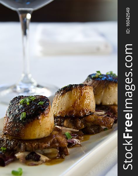 Pan seared scallops over pork belly with radicchio