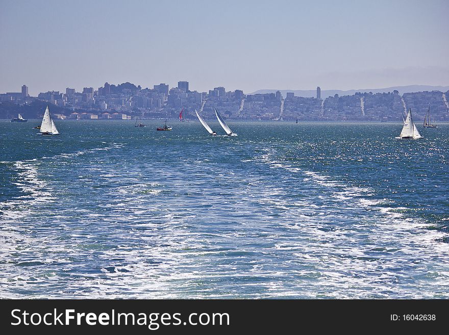 Waves from a ferry boat with San Francisco skyline in the background. Waves from a ferry boat with San Francisco skyline in the background