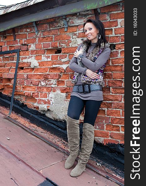 Portrait of a girl on the roof. Brick wall separates two houses. Portrait of a girl on the roof. Brick wall separates two houses