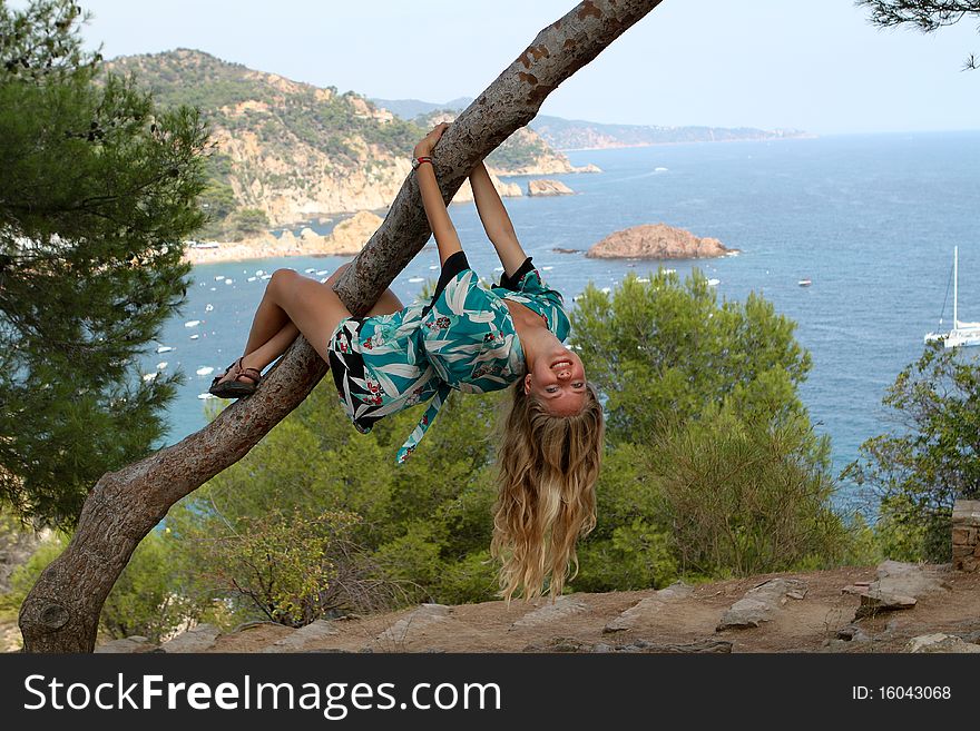 Girl is hanging on the tree. Spain. Summer. Girl is hanging on the tree. Spain. Summer.
