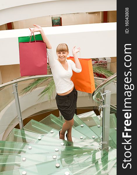 Beauty woman shopping in mall with colored bag