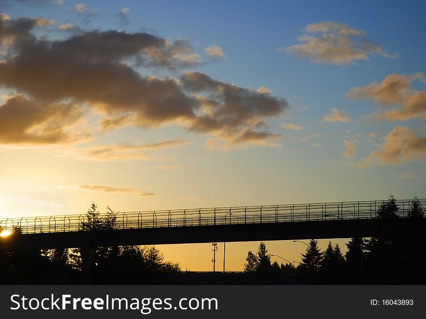 View of a pedestrian overpass over I-5
interstate freeway at sunset. View of a pedestrian overpass over I-5
interstate freeway at sunset