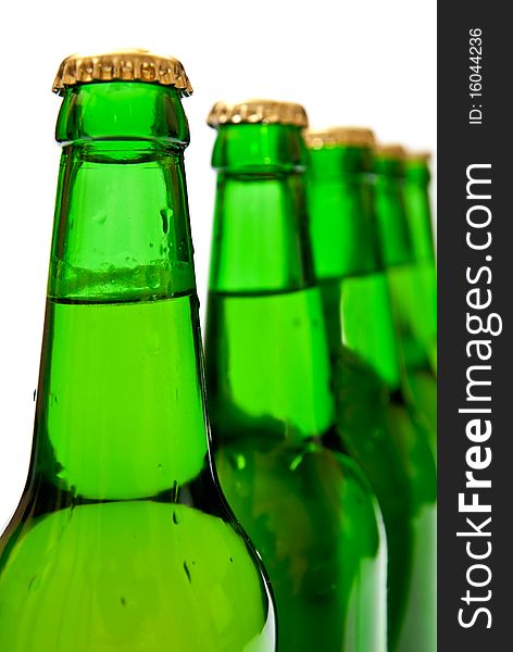 Row from beer bottles. Isolated on white background