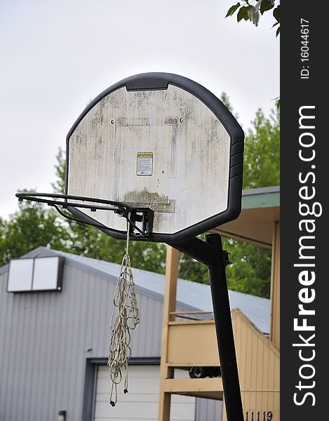 Old and worn out basketball board and hoop. For sports and recreation, and health and fitness concepts. Old and worn out basketball board and hoop. For sports and recreation, and health and fitness concepts.