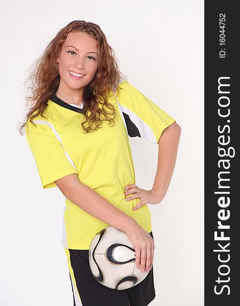 Smiling beautiful football girl in yellow t-shit and ball