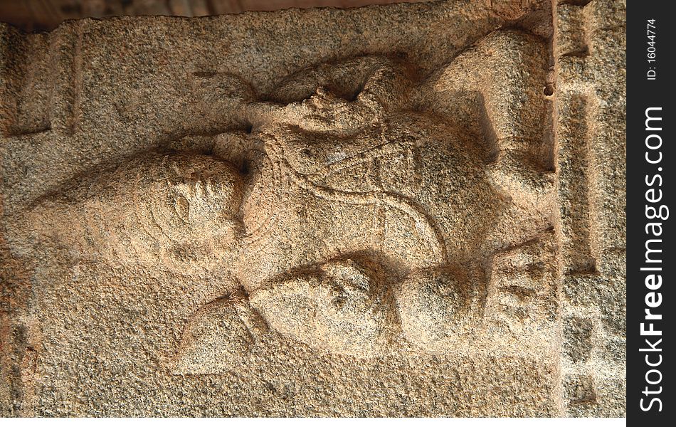 Figure in sedentary posture holding lotus buds at Krishna Temple, Hampi, Karnataka, India, Asia. Figure in sedentary posture holding lotus buds at Krishna Temple, Hampi, Karnataka, India, Asia
