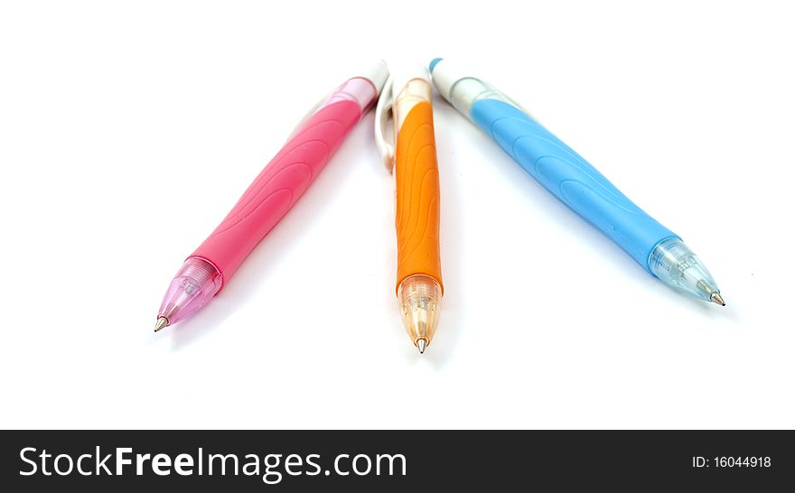 Colored pens on a white background